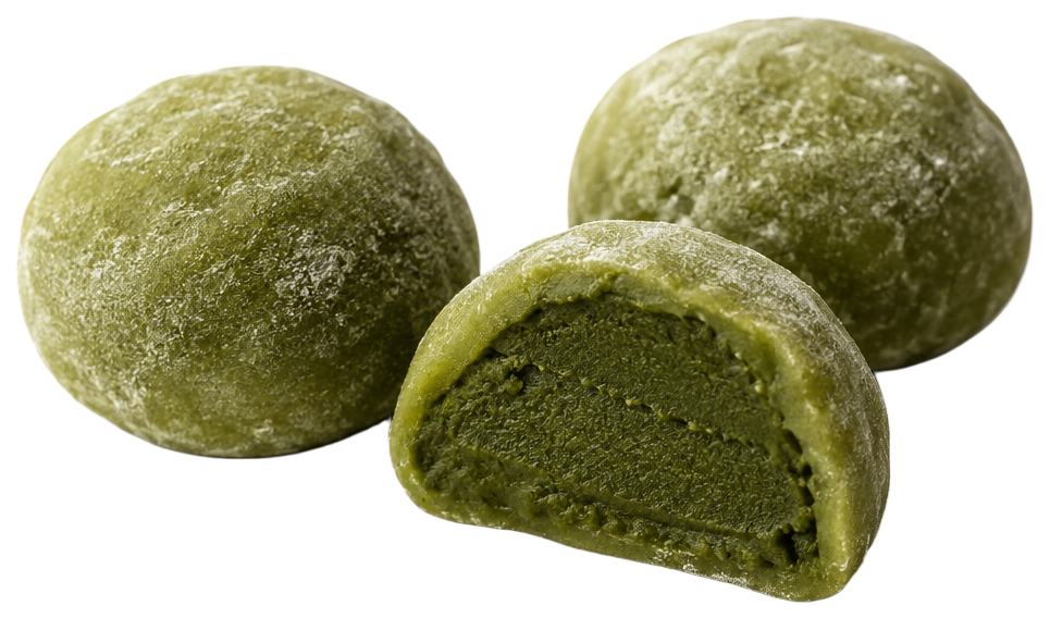 Three handmade matcha mochi dusted with rice flour, one cut in half to show the dense matcha filling